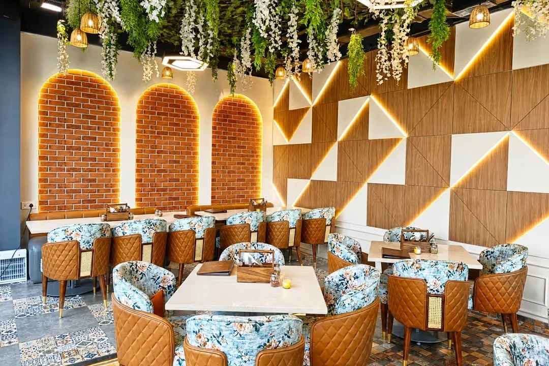 Warmly lit brick arches, hanging flowers and welcoming dining tables at DO-DO-S